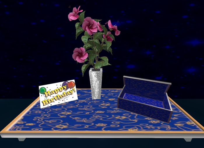  Gift table with greeting card , bouquet of flowers and gif