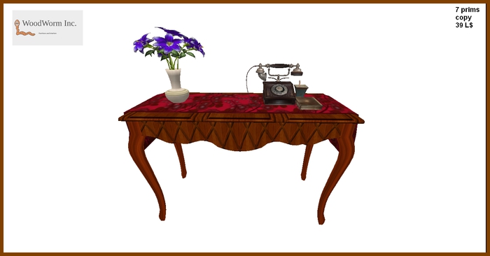 A vintage commode with an antique phone and flowers