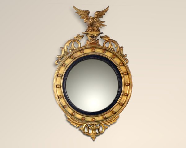 A Classical Ebonized And Carved Giltwood Convex Mirror