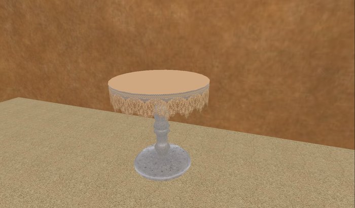 Round table with beige lace table cloth